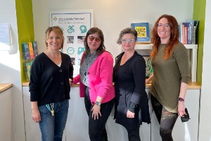 A picture of four women, the staff of the AT Lab, standing in The Lab.